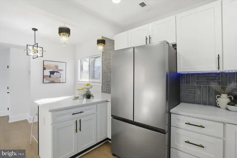 a kitchen with stainless steel appliances a refrigerator sink and cabinets