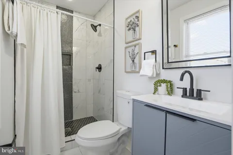 a bathroom with a shower and a toilet