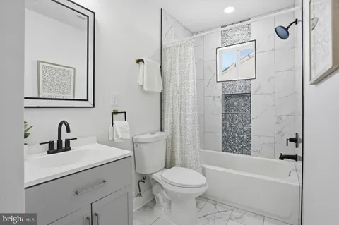 a bathroom with a toilet and a bathtub