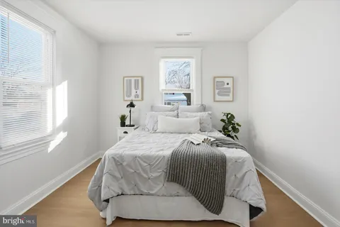 a bedroom with furniture and a window