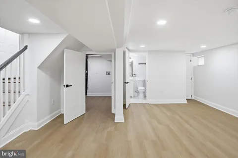 a bathroom with a sink a toilet and mirror