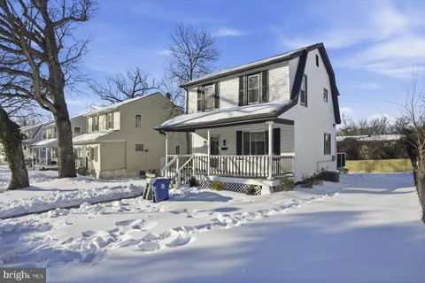 a view of a swimming pool with a yard and wooden fence