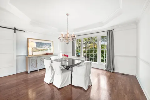 a kitchen that has a lot of cabinets in it and stainless steel appliances