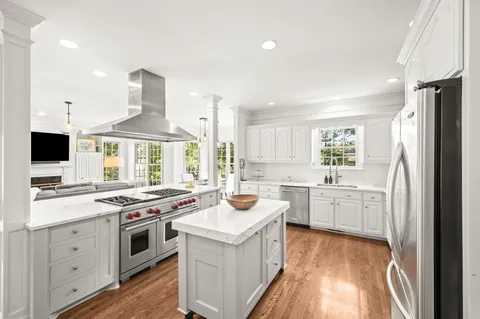 a kitchen with a refrigerator a stove a sink and a refrigerator