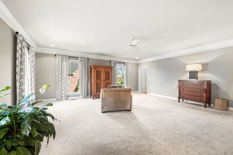 a dining room with furniture and a floor to ceiling window