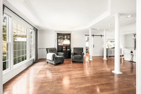a view of a dining room with furniture window and wooden floor