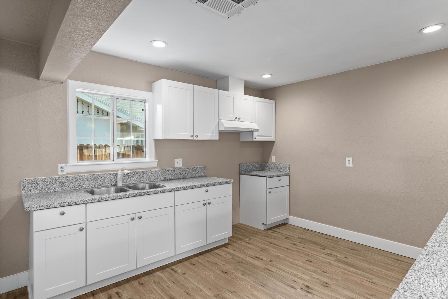 Undisclosed Address Bakersfield, CA 93305 - Photo 12 of 32 a kitchen with a sink window and cabinets
