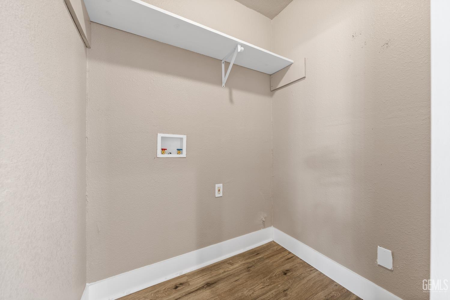 Undisclosed Address Bakersfield, CA 93305 - Photo 15 of 32 a view of a room with wooden floor and empty racks