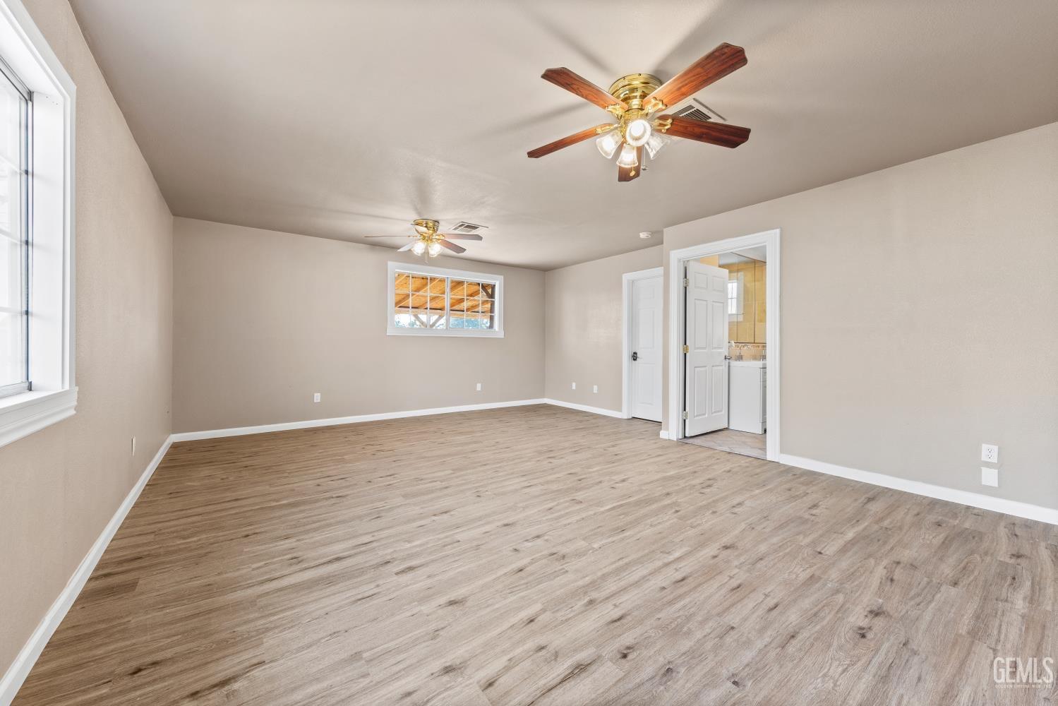 Undisclosed Address Bakersfield, CA 93305 - Photo 17 of 32 a view of an empty room with window and wooden floor