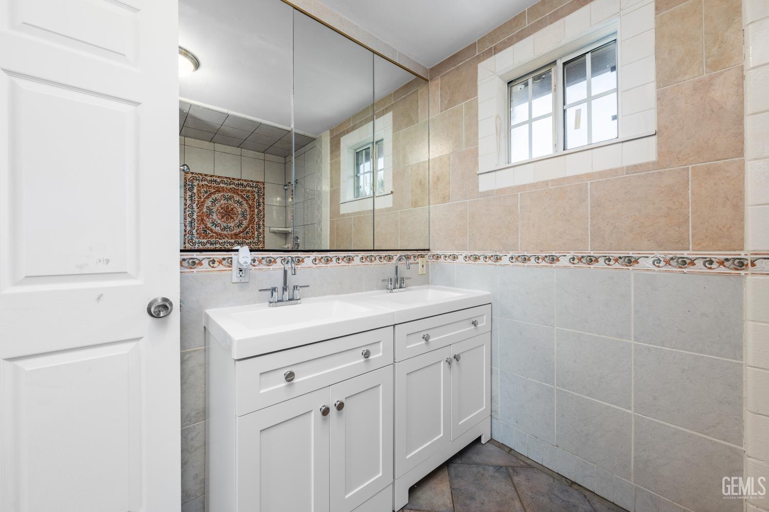 Undisclosed Address Bakersfield, CA 93305 - Photo 20 of 32 a bathroom with a sink and a mirror