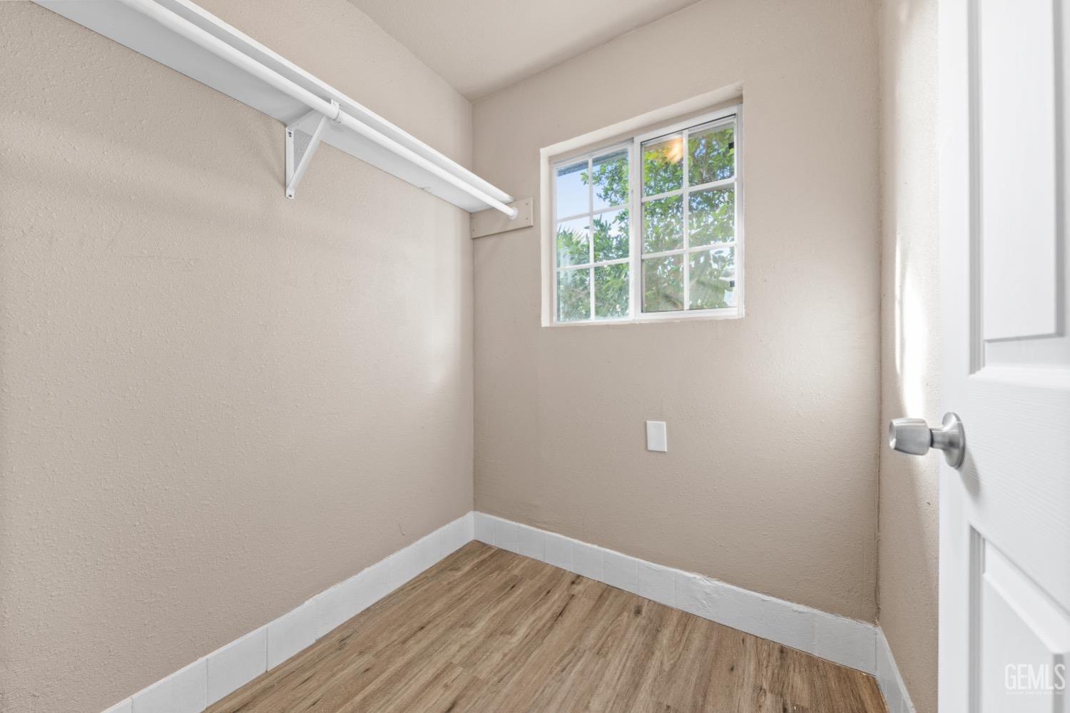 Undisclosed Address Bakersfield, CA 93305 - Photo 21 of 32 a view of a small space with wooden floor and a window