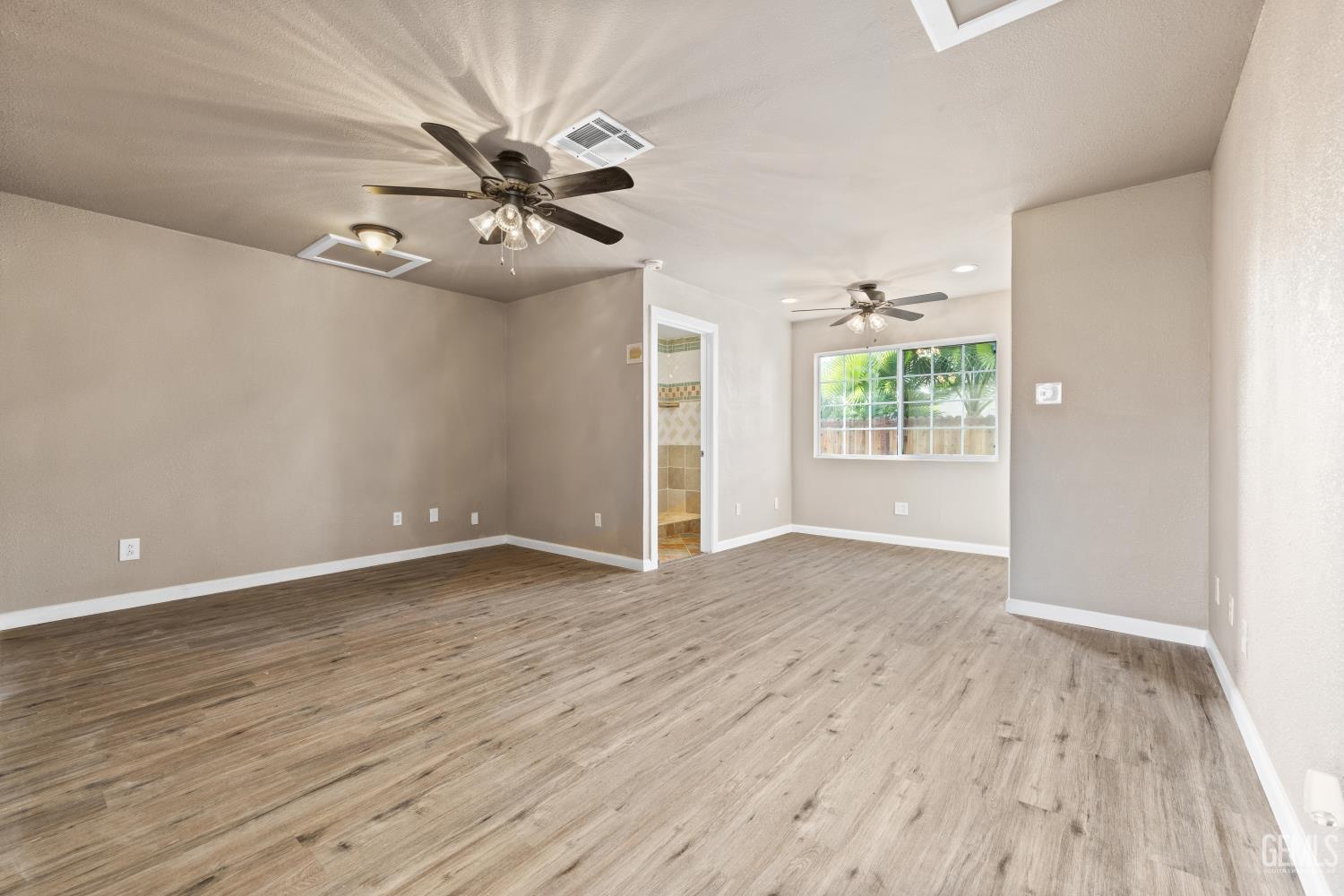 Undisclosed Address Bakersfield, CA 93305 - Photo 22 of 32 wooden floor in an empty room with a window