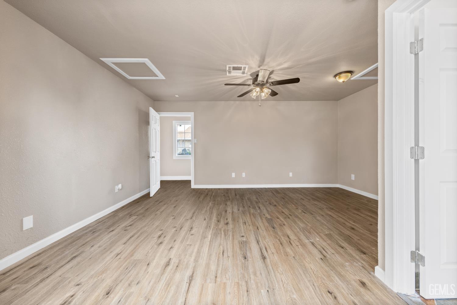 Undisclosed Address Bakersfield, CA 93305 - Photo 23 of 32 a view of an empty room with wooden floor