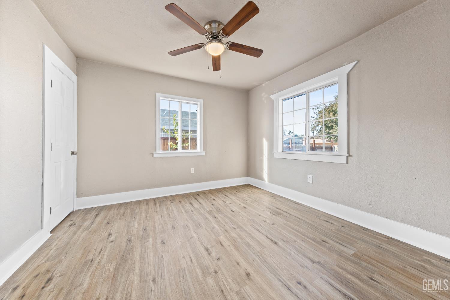 Undisclosed Address Bakersfield, CA 93305 - Photo 25 of 32 a view of an empty room with wooden floor and a window