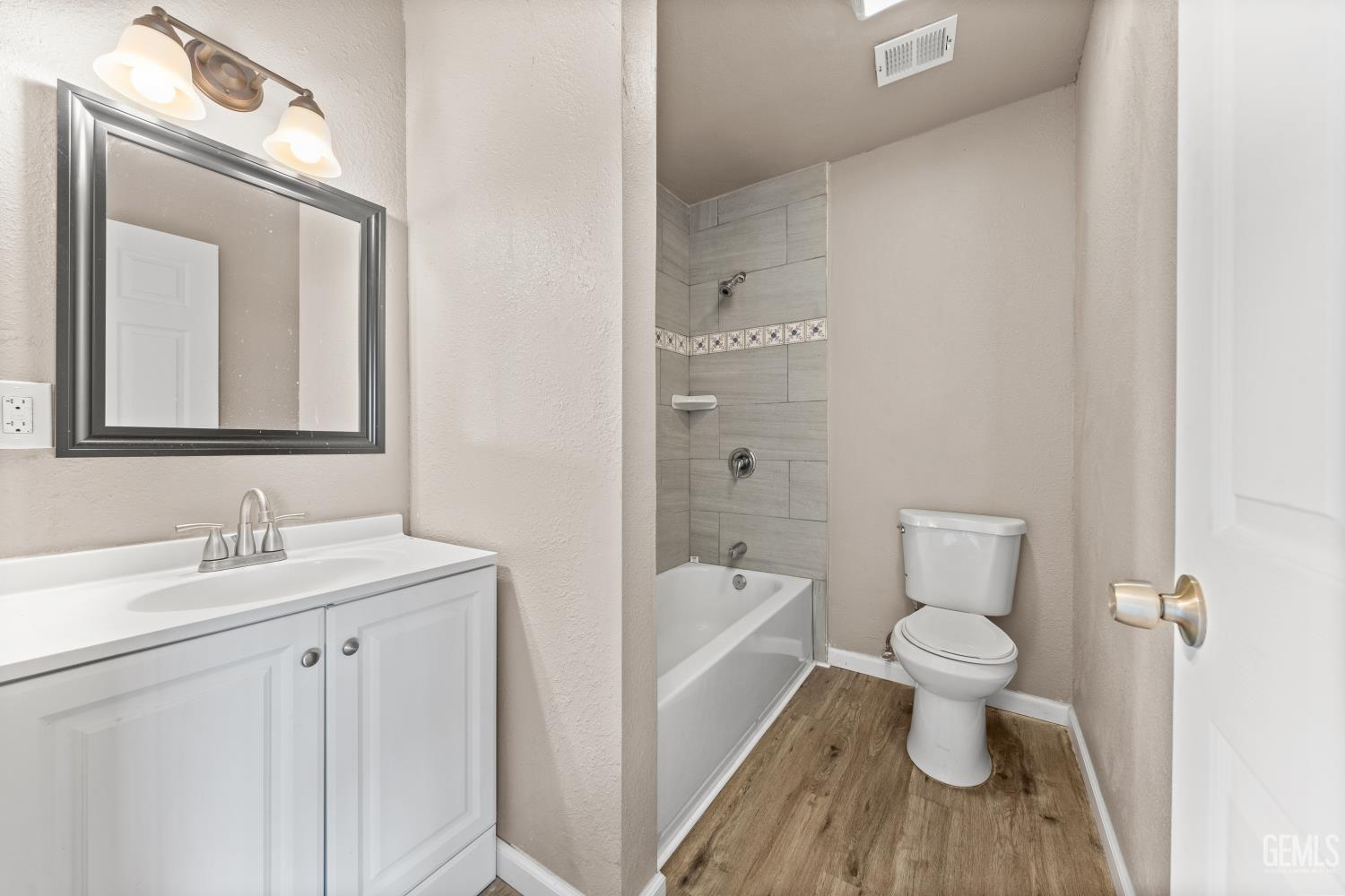 Undisclosed Address Bakersfield, CA 93305 - Photo 27 of 32 a bathroom with a toilet a sink a tub and mirror