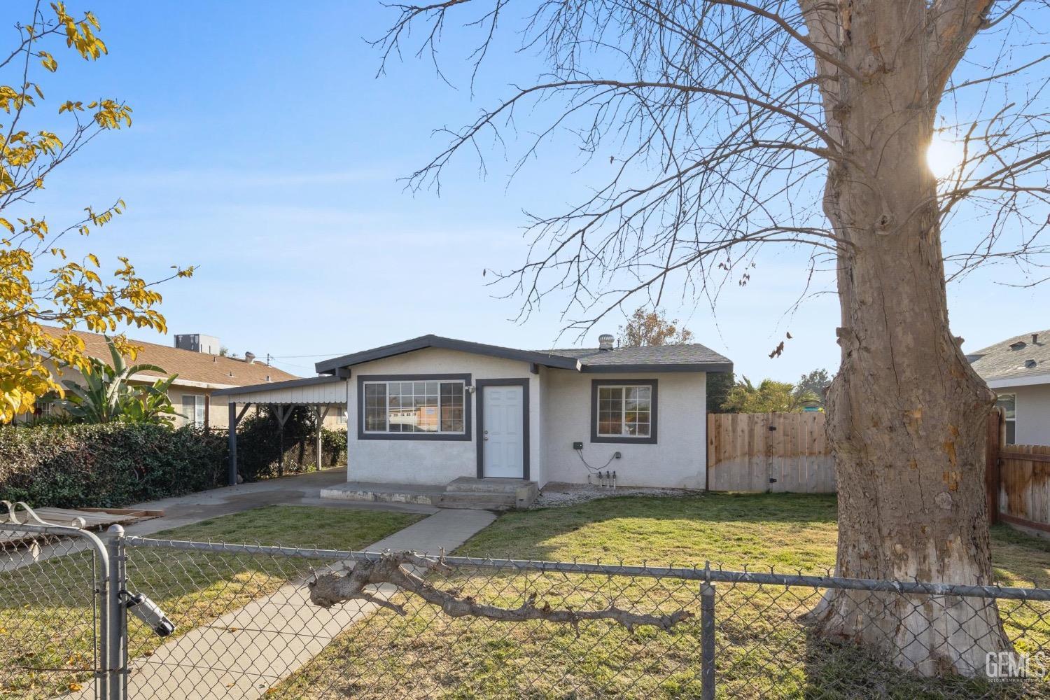 Undisclosed Address Bakersfield, CA 93305 - Photo 3 of 32 a front view of a house with a yard