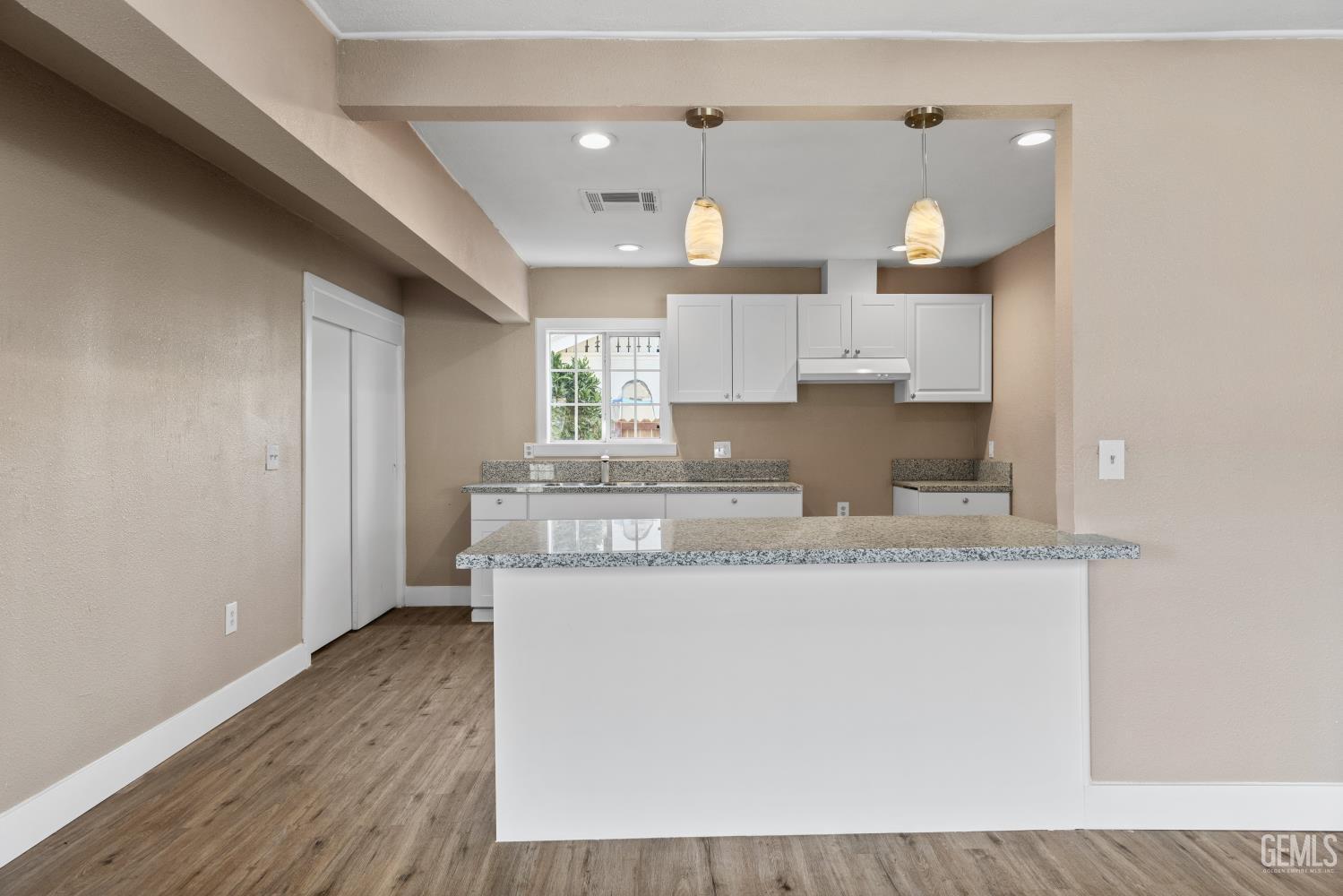 Undisclosed Address Bakersfield, CA 93305 - Photo 10 of 32 a kitchen with granite countertop a sink cabinets and wooden floor