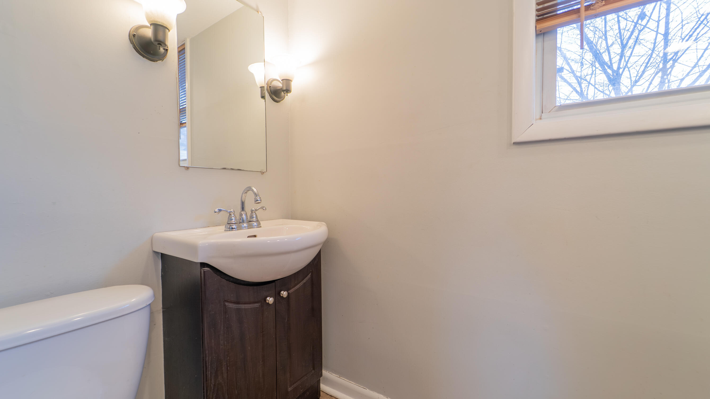 6318 Garfield Street Merrillville, IN 46410 - Photo 12 of 27 a bathroom with a sink a toilet and mirror