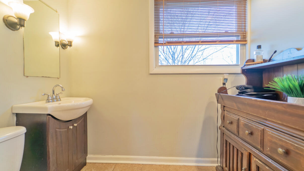 6318 Garfield Street Merrillville, IN 46410 - Photo 13 of 27 a bathroom with a sink and a mirror