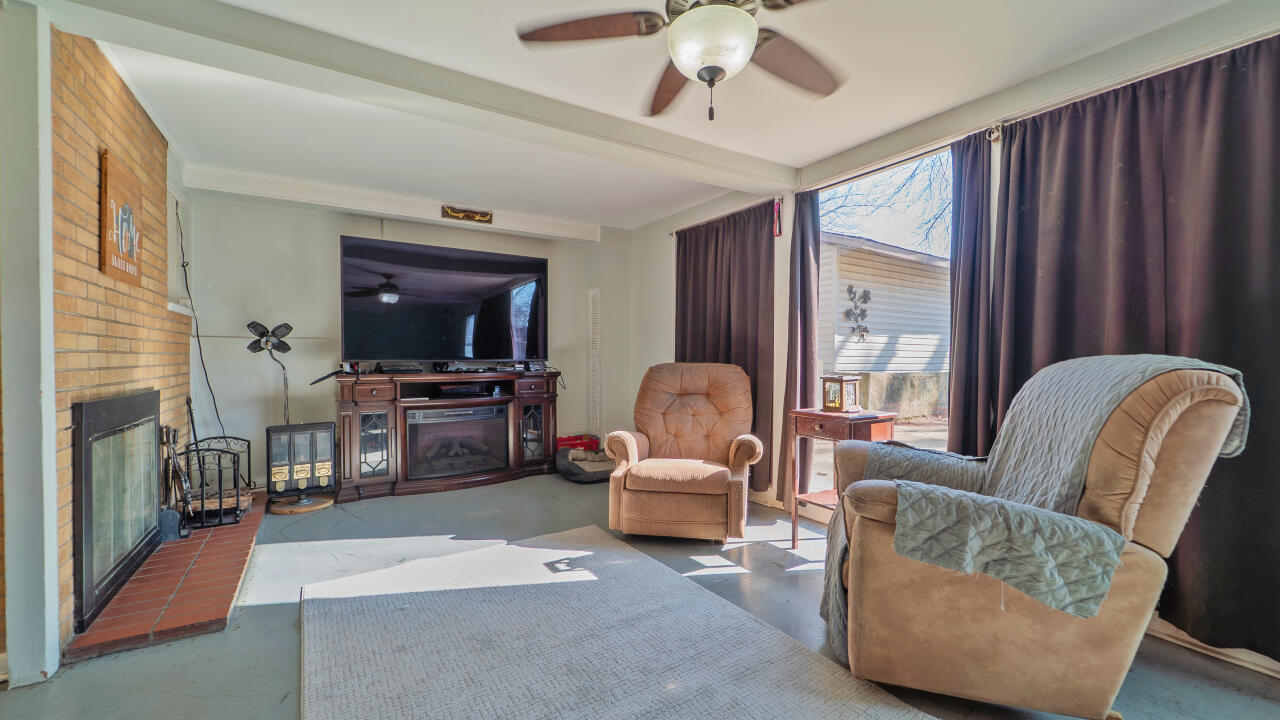 6318 Garfield Street Merrillville, IN 46410 - Photo 16 of 27 a living room with furniture and a flat screen tv