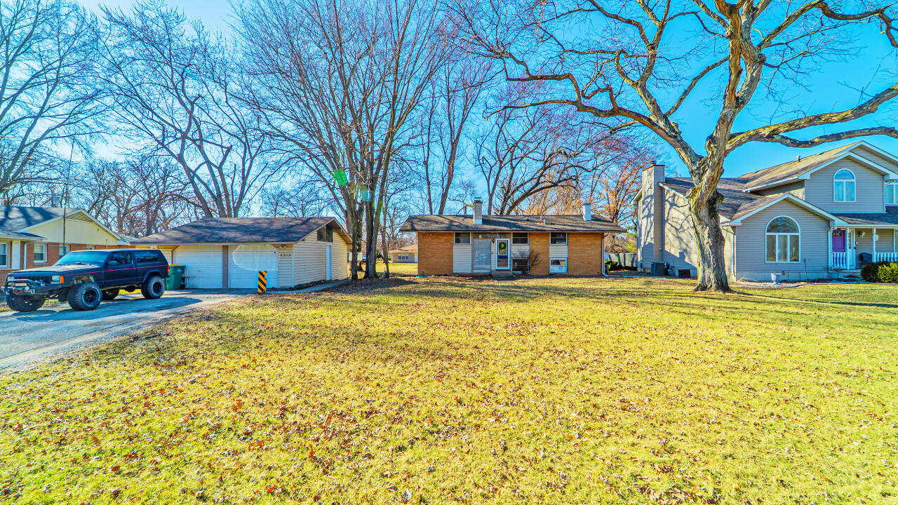 6318 Garfield Street Merrillville, IN 46410 - Photo 3 of 27 a front view of a house with a garden
