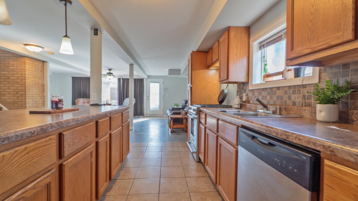 6318 Garfield Street Merrillville, IN 46410 - Photo 6 of 27 a kitchen with stainless steel appliances a sink stove and cabinets