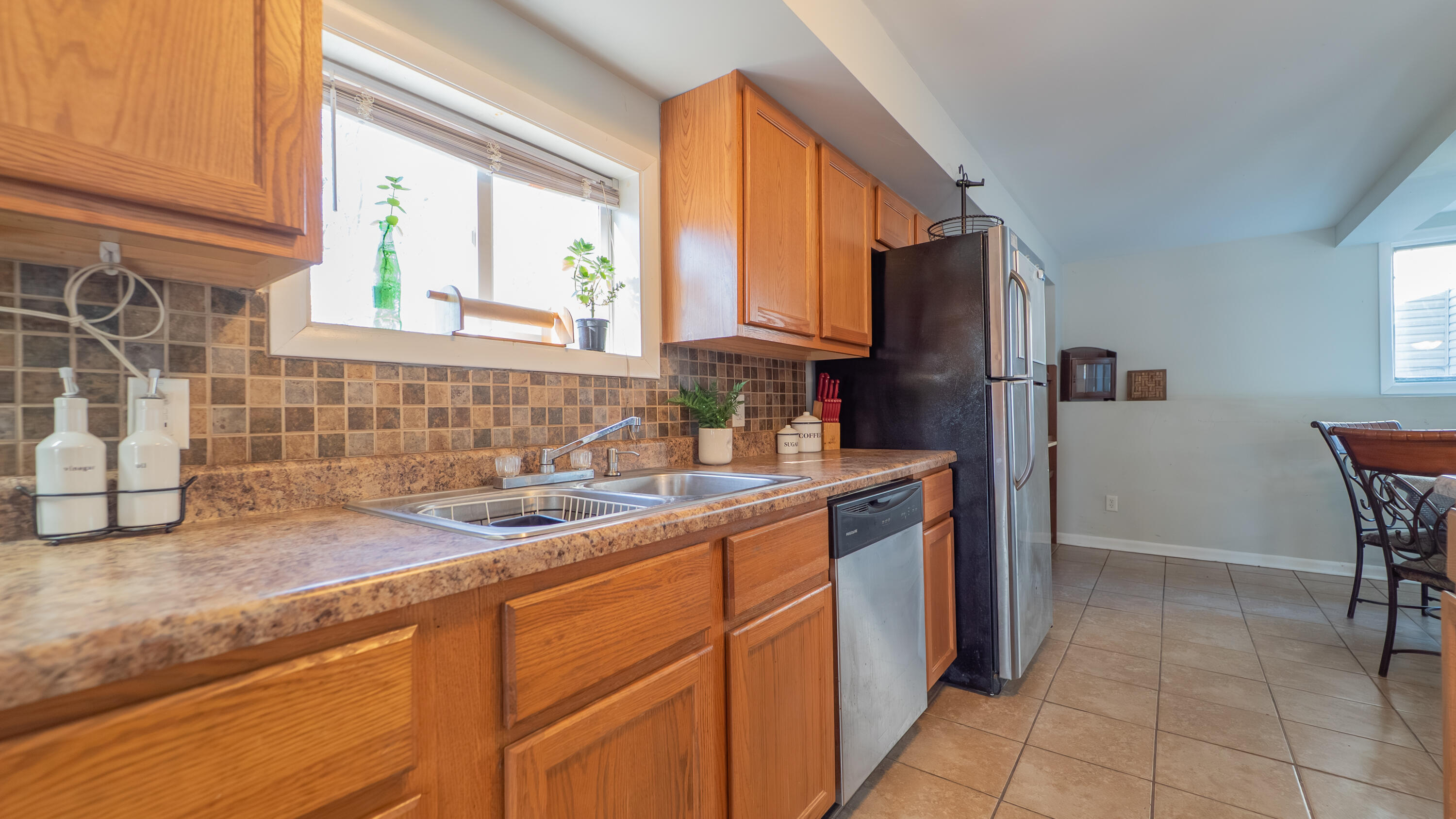 6318 Garfield Street Merrillville, IN 46410 - Photo 8 of 27 a kitchen with stainless steel appliances granite countertop a sink and a refrigerator
