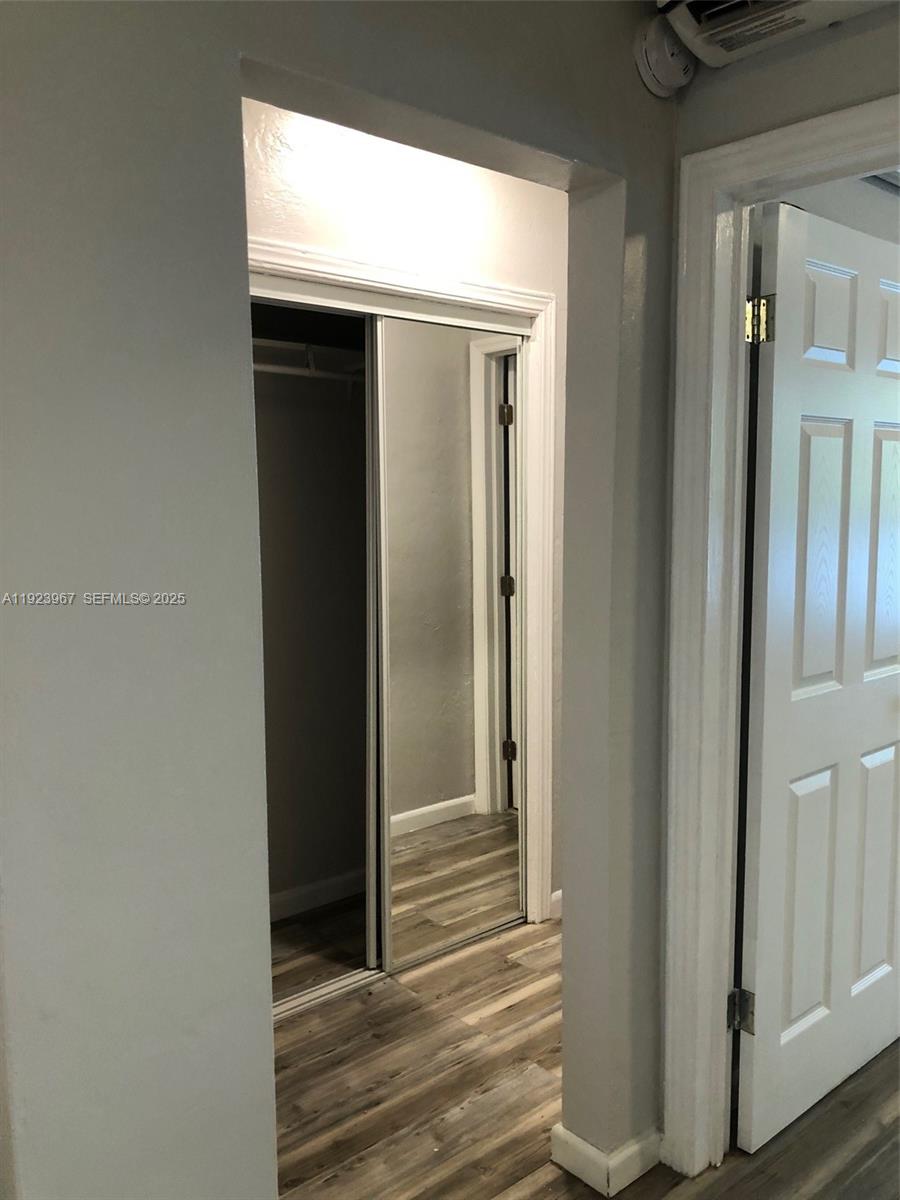 570 Northeast 69th Street, Unit 2 Miami, FL 33138 - Photo 12 of 21 a view of a hallway with wooden floor and closet