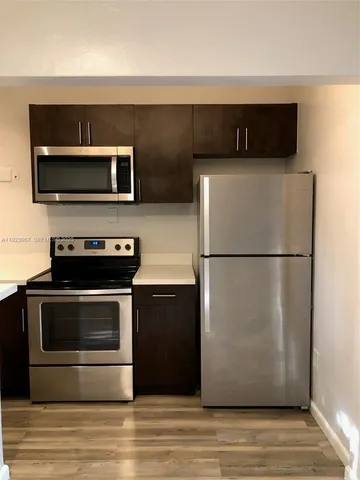 a kitchen with a refrigerator stove and microwave