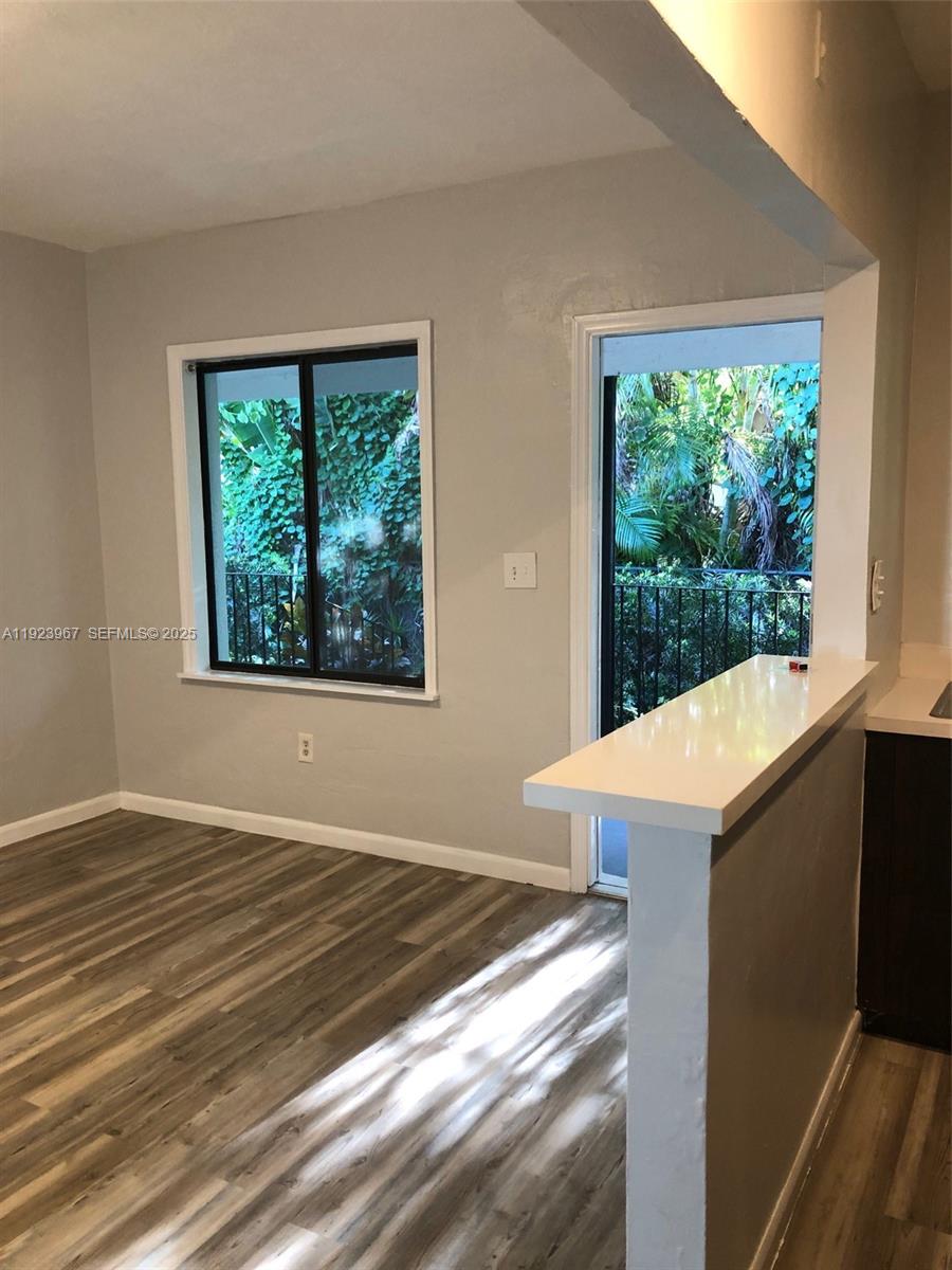 570 Northeast 69th Street, Unit 2 Miami, FL 33138 - Photo 20 of 21 a view of an empty room with wooden floor and a window