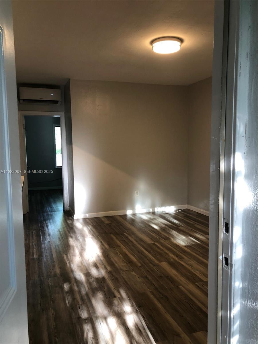 570 Northeast 69th Street, Unit 2 Miami, FL 33138 - Photo 6 of 21 a view of empty room with wooden floor