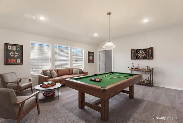 a living room with furniture a table and a chandelier