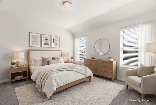 a bedroom with a bed a couch and dresser