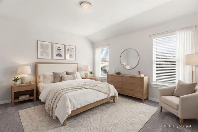 a bedroom with a bed a couch and dresser