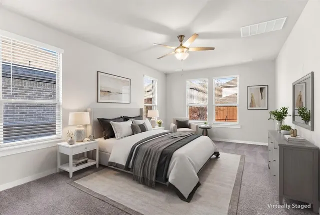 a spacious bedroom with a bed and a chandelier