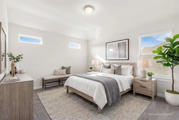 a bedroom with a bed and a couch