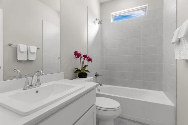 a view of an empty room with closet and a window