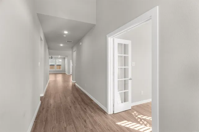 a view of hallway with wooden floor