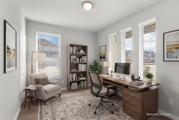 a view of a workspace with a window and lounge chair