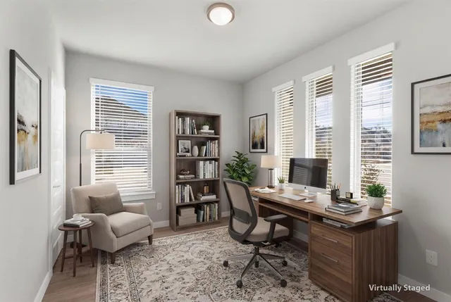 a view of a workspace with a window and lounge chair
