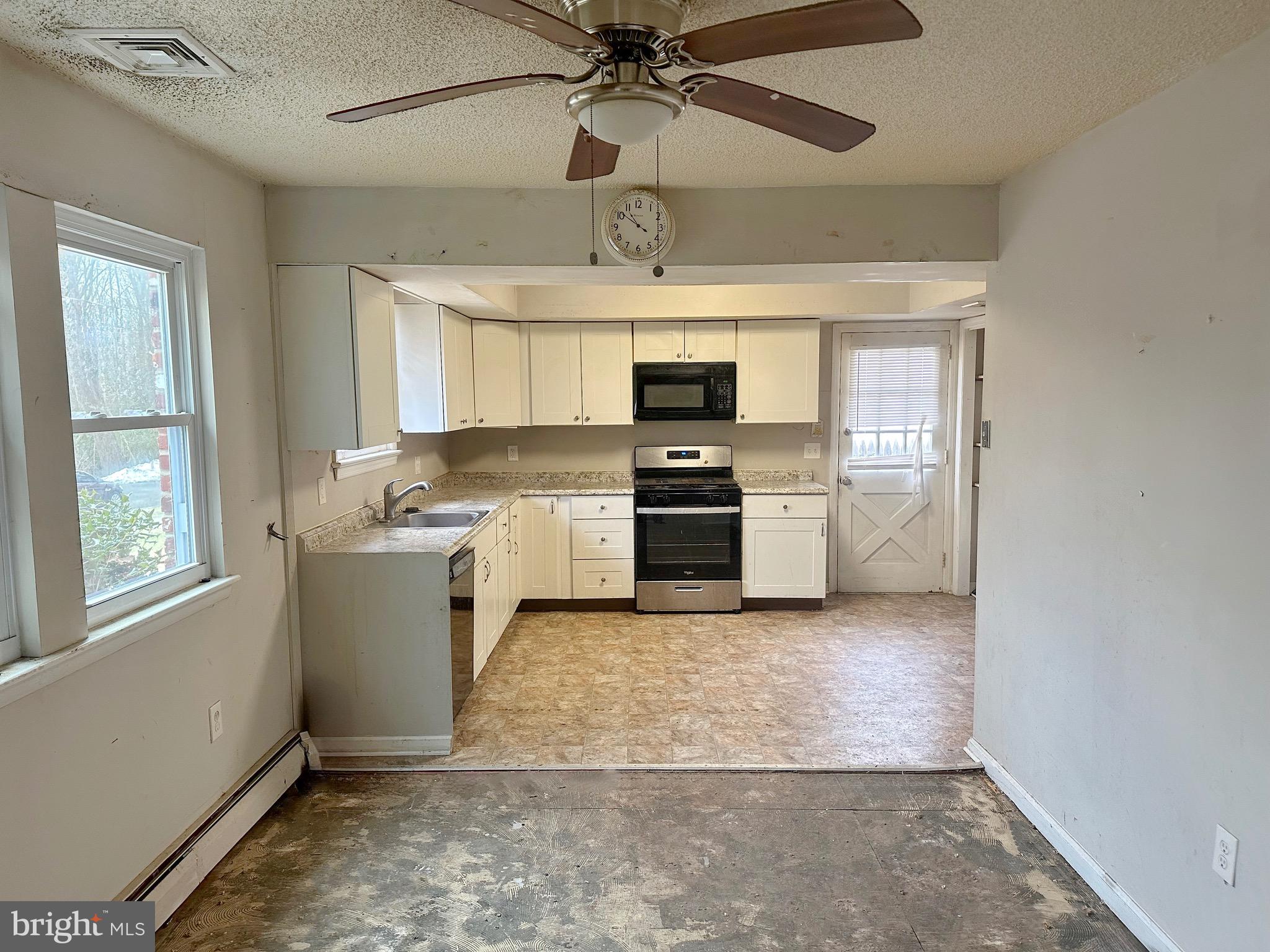 220 Myrtle Avenue Lindenwold, NJ 08021 - Photo 10 of 11 a kitchen with a stove a sink and a microwave