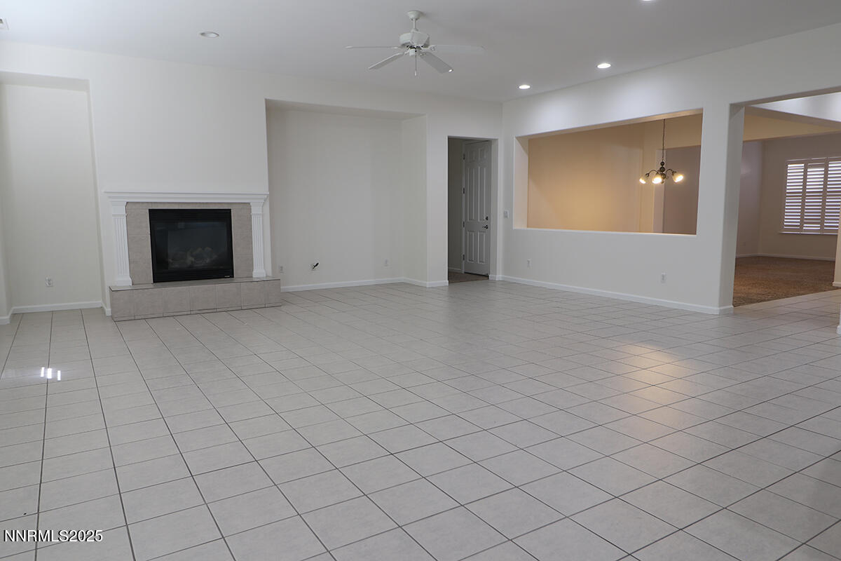 1692 Broadstone Way Reno, NV 89521 - Photo 12 of 31 an empty room with windows and fireplace
