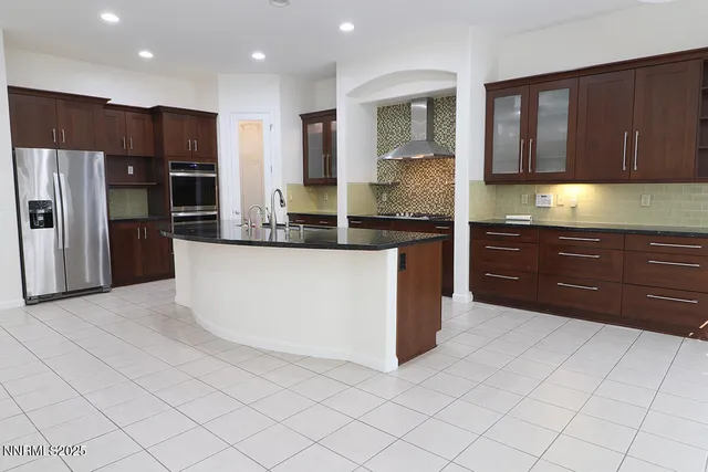 a kitchen with stainless steel appliances a stove a sink and a refrigerator