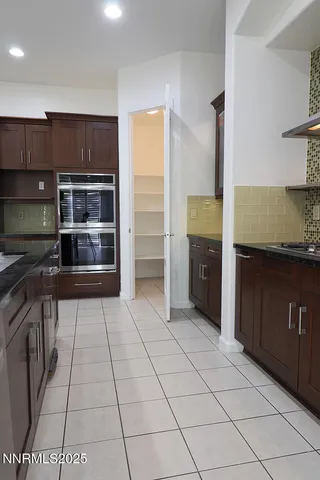 a kitchen with granite countertop cabinets and window
