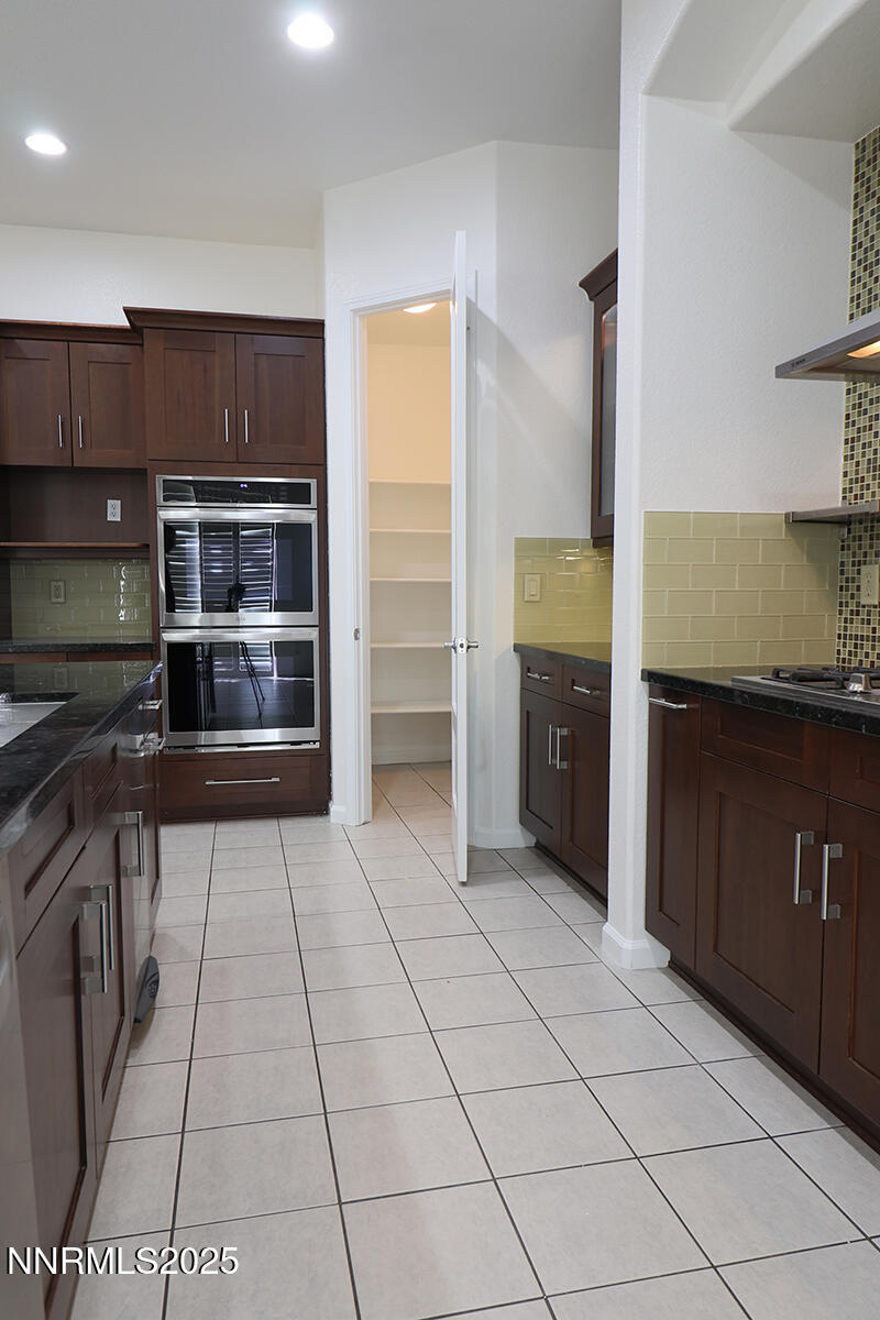 1692 Broadstone Way Reno, NV 89521 - Photo 15 of 31 a kitchen with stainless steel appliances a stove a sink and a refrigerator