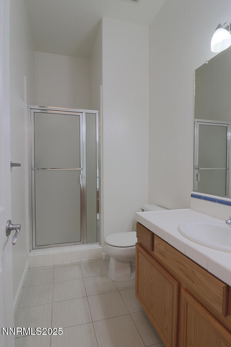 1692 Broadstone Way Reno, NV 89521 - Photo 23 of 31 a bathroom with a sink a toilet and vanity