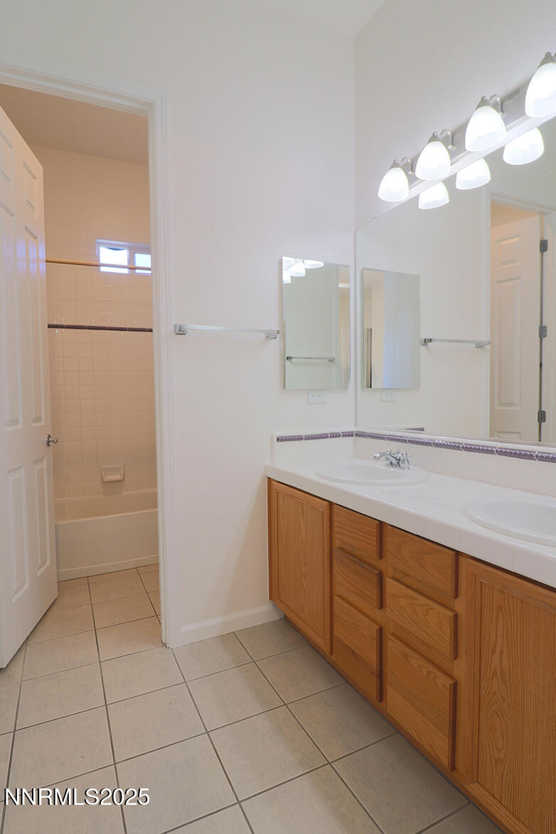 1692 Broadstone Way Reno, NV 89521 - Photo 24 of 31 a bathroom with a sink a mirror and a shower