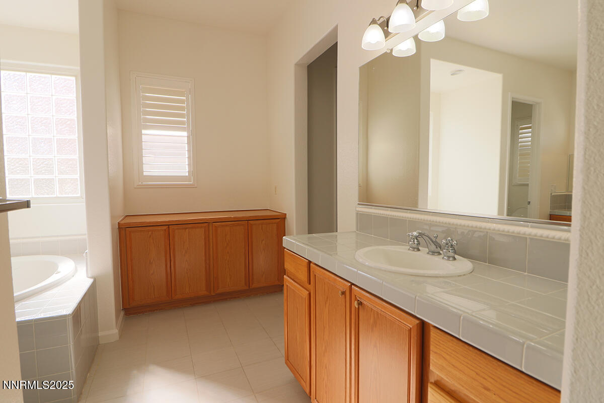 1692 Broadstone Way Reno, NV 89521 - Photo 25 of 31 a bathroom with a sink a vanity and a mirror