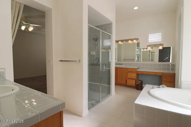 a bathroom with a shower sink and mirror
