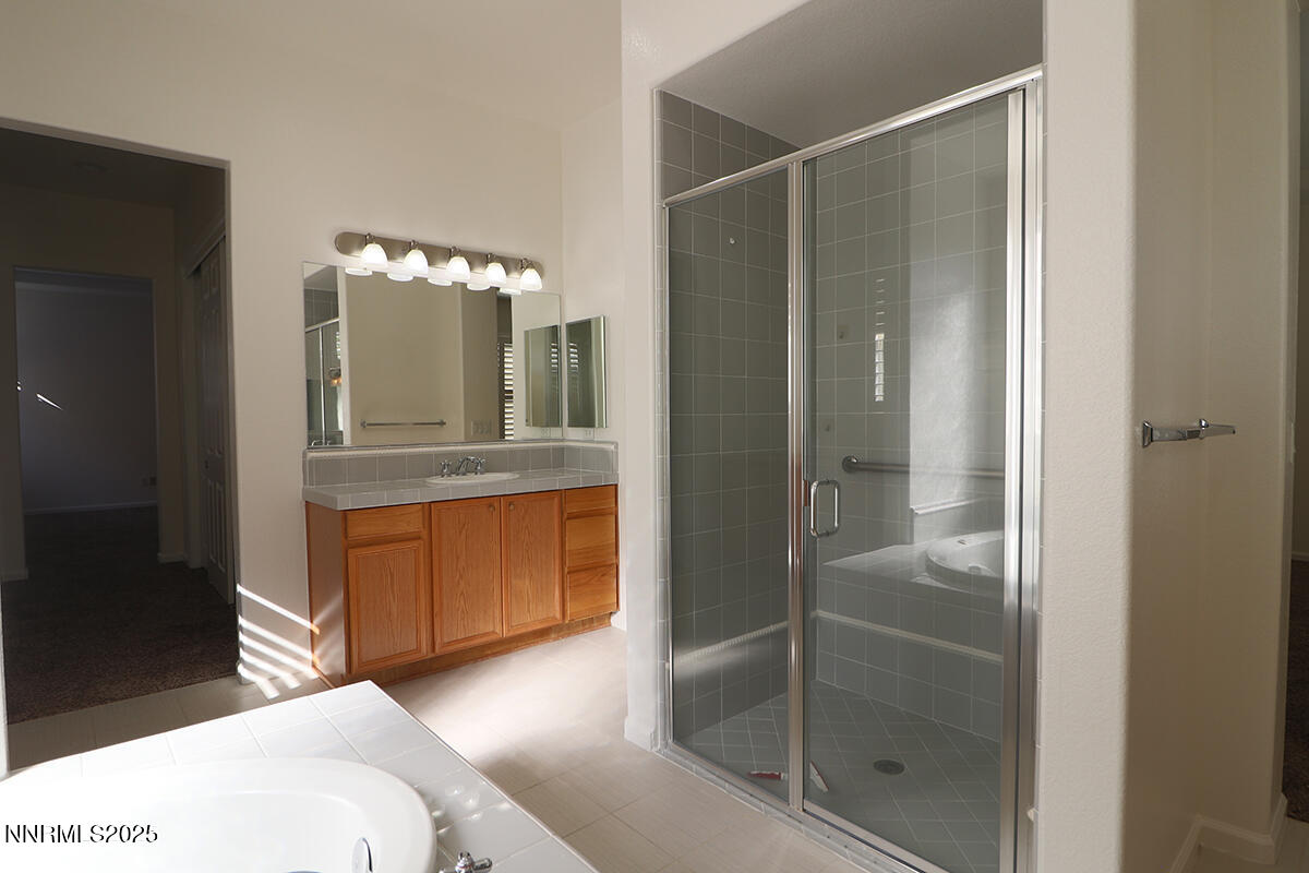 1692 Broadstone Way Reno, NV 89521 - Photo 27 of 31 a bathroom with a shower sink and mirror